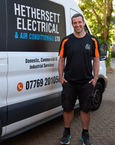 Scott from Hethersett Electrical standing beside the branded company van