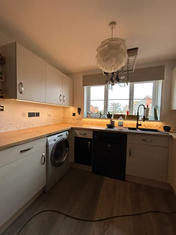 Finished kitchen with under-cabinet lighting, sockets and a pendant light