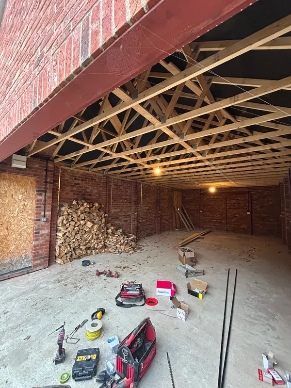 First-fix power and lighting cabling in a commercial building with exposed roof trusses