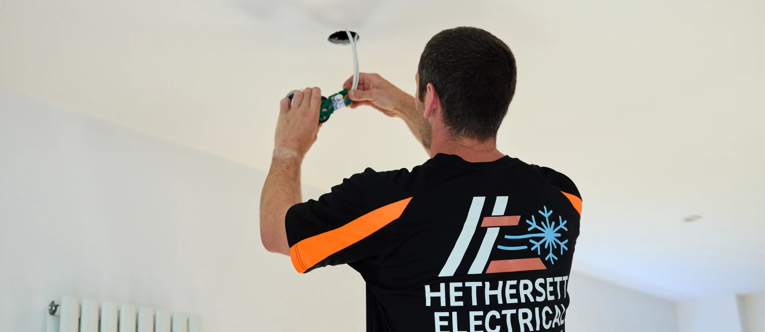 Hethersett Electrical engineer wiring a new ceiling downlight during a house rewire